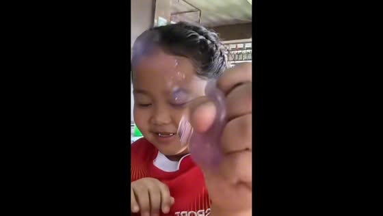 Girl bursts squishy toy in unexpected playtime mishap in Surat Thani, Thailand