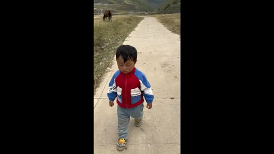 Sleepy child’s nap ends with a tumble on the road in Sichuan, China