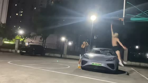 Basketball player dunks over car during exhibition in Zhejiang, China