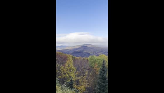Scenic rainbow appears over colorful autumn foliage in Jackson, New Hampshire, USA