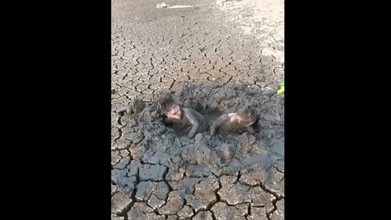 Children play in mud in Jiangsu, China