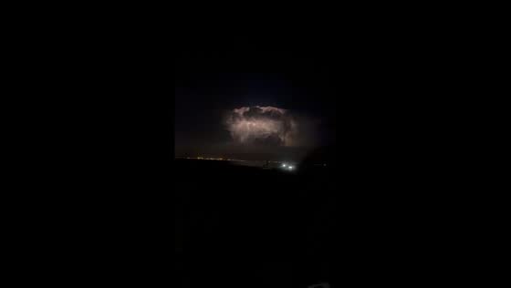 Strong lightning illuminates thunderstorm clouds over Paralimni, Cyprus
