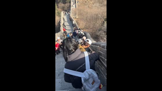 Person slips on Great Wall stairs but is stopped by bystanders in Beijing, China