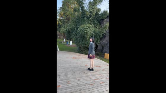 Young woman performs backflip with full twist on outdoor stage in Yunnan, China