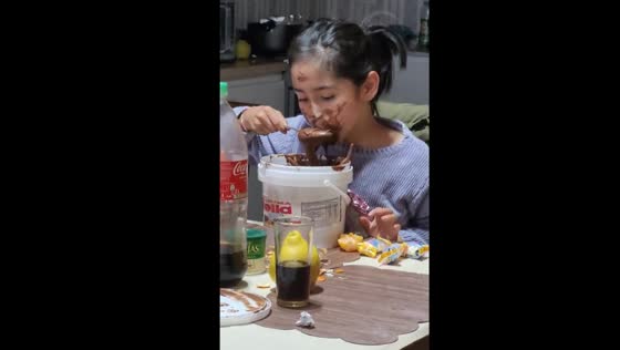 Messy delight: child dives into Nutella bucket in Valdivia, Chile