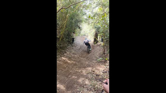 Boy crashes bicycle into bushes on downhill trail in Gorbea, Chile