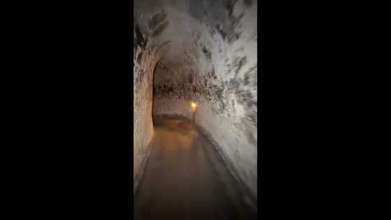 Visitor demonstrates narrow passage inside Cu Chi Tunnels in Ho Chi Minh, Vietnam