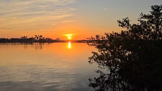 Vibrant sunrise reflecting on calm lake, Port Orange, Florida, USA