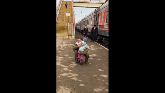 Young girl runs to hug father returning home at train station in Prokhladn, Russia