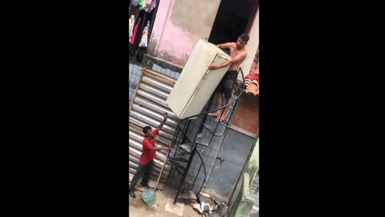 Fridge mishap on narrow stairs in Fortaleza