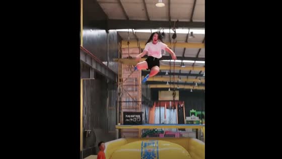 Trampoline game in Guangzhou sends one person soaring into foam balls.