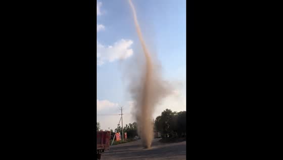 Dust devil spins beside road in Henan, China