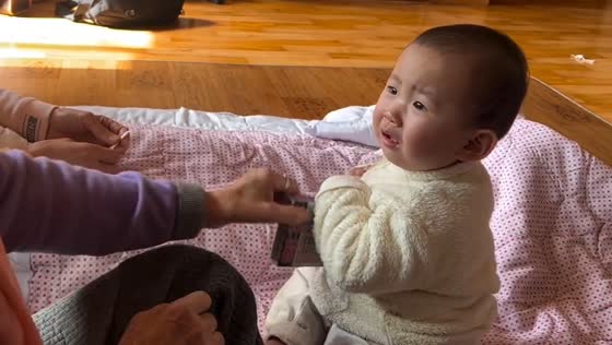 Baby fiercely refuses to give up item to relative
