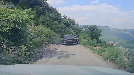 Motorcyclist slips near cliff edge and grabs rocks to avoid fall in Xinxiang, Henan, China