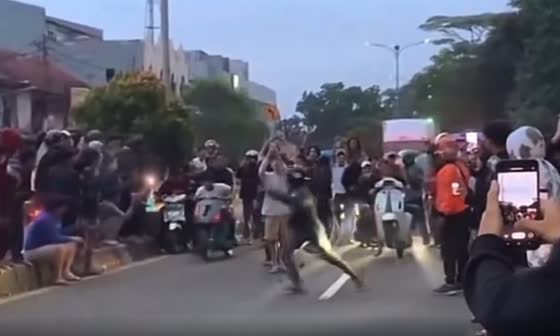 A racing event in Indonesia takes an unexpected turn as a man is struck by a motorcycle