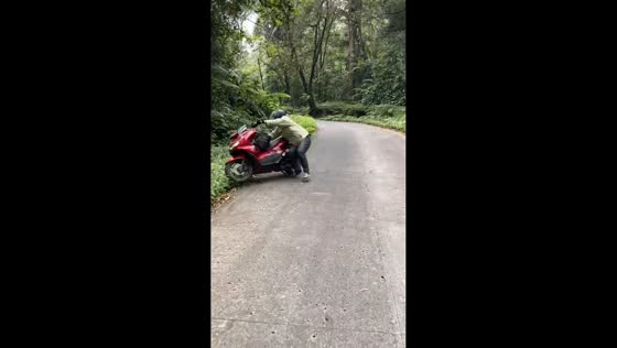 Motorbike mishap sends rider into bushes in Pekalongan, Indonesia