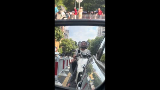 Three riders wearing funny masks spotted on scooter behind in Hunan, China
