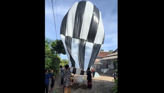 People fill balloon with hot air over fire in Blitar, East Java