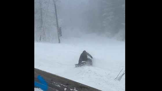 Person sledding on snow falls down in Oslo Norway
