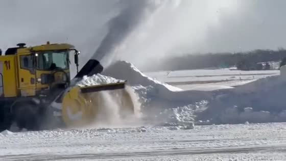 Snowplows clear runways ahead of lake-effect snow at Rochester airport, USA