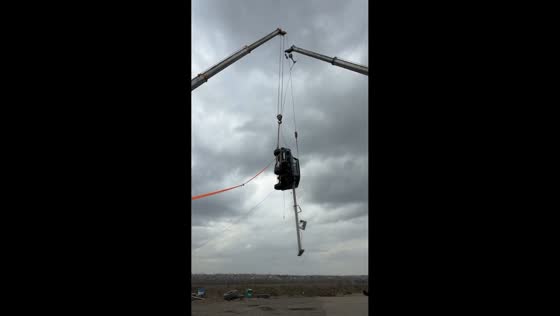 Man performs extreme crane-suspended SUV performance in Rostov-on-Don, Russia
