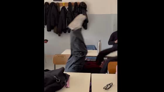 Student falls off chair after envelope thrown at them in Naples, Italy