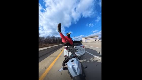 Motorbike rider crashes into vehicle 