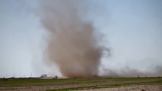 Dust devil grows and sweeps across field in Saragosa, Texas, USA
