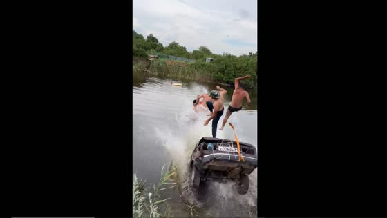 Daring stuntmen take a plunge in a private pond on a car