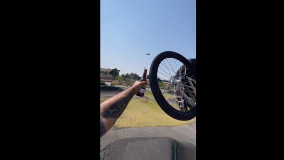 Bicycle trick: opening soda can with rear tire move