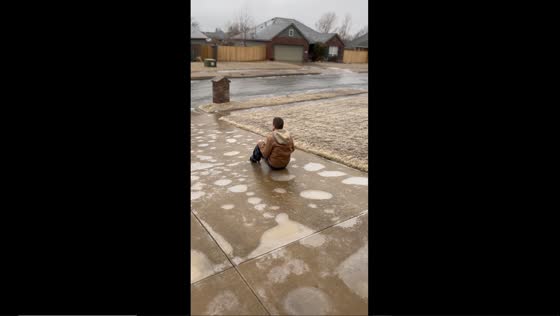 Icy adventure: Daniel slides down frozen driveway in Sand Springs, Oklahoma