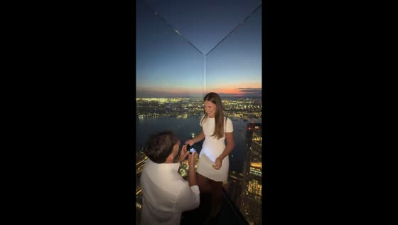 Man proposes to girlfriend during rooftop date overlooking New York City skyline, USA