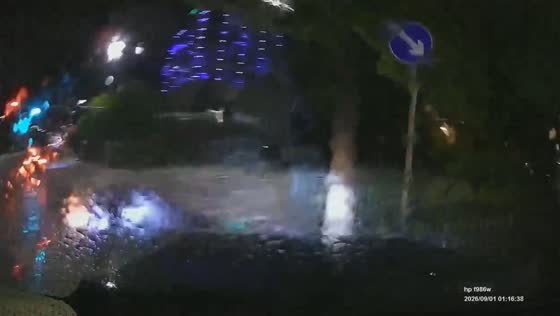 Delivery rider collides with car on a wet street after heavy water splashes in Hunan, China