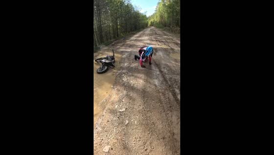 Motorcyclist falls after hitting muddy rut on forest road near Irkutsk, Russia