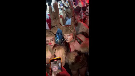 Festive costume party with shirtless reindeer and Santa in São Paulo, Brazil
