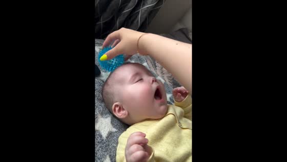 8-month-old baby soothed by ball massage