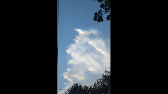 Rainbow-like colors appear along sunlit cloud over Lahore, Pakistan
