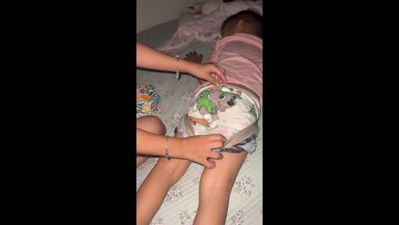 Little boy sleeps wearing multiple layers of underwear in Neimenggu, China