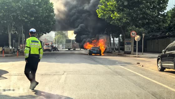 Firefighters extinguish burning car in Liaoning, China
