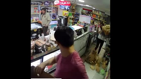Woman trips and drops bread crate on man in Santiago, Chile