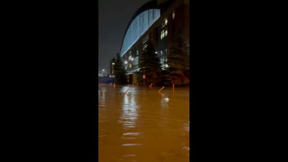 Residents walk through flooded streets after heavy rain in Milwaukee, USA