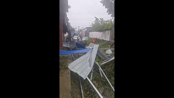 Roofs and debris scattered across a residential area in Hebei, China