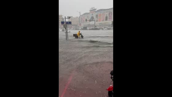Motorcyclist rides through flooded road in Tieling, Liaoning, China