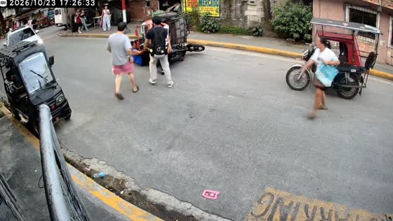 Tricycle tips over after getting caught on a low-hanging cable in Manila, Philippines