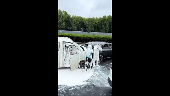 Drivers covered in white paint after latex spill in Shanghai, China