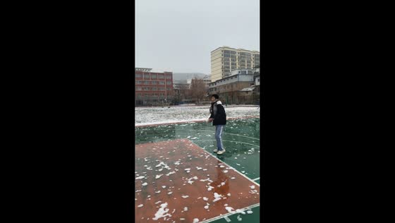 Friends play basketball with snow in Gansu, China