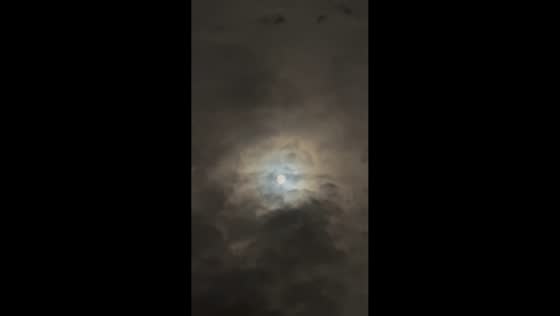 Bright moonlight shines through clouds in Belwood, Canada