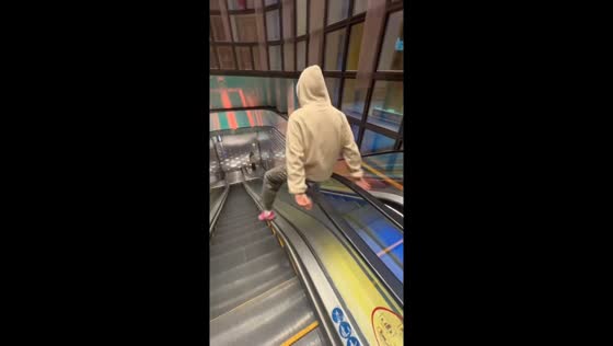 Person slides down escalator handrail in Guangdong, China