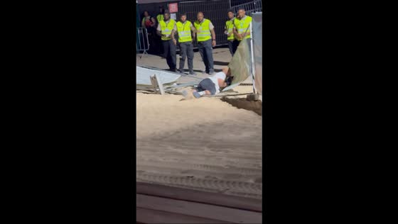 Drunk man repeatedly stumbles and falls into fence at Afro Nation in Algarve, Faro, Portugal