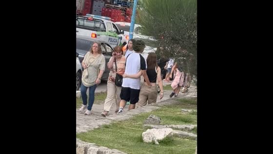 Man’s hand in woman’s pants as they walk together in Tafí del Valle, Argentina